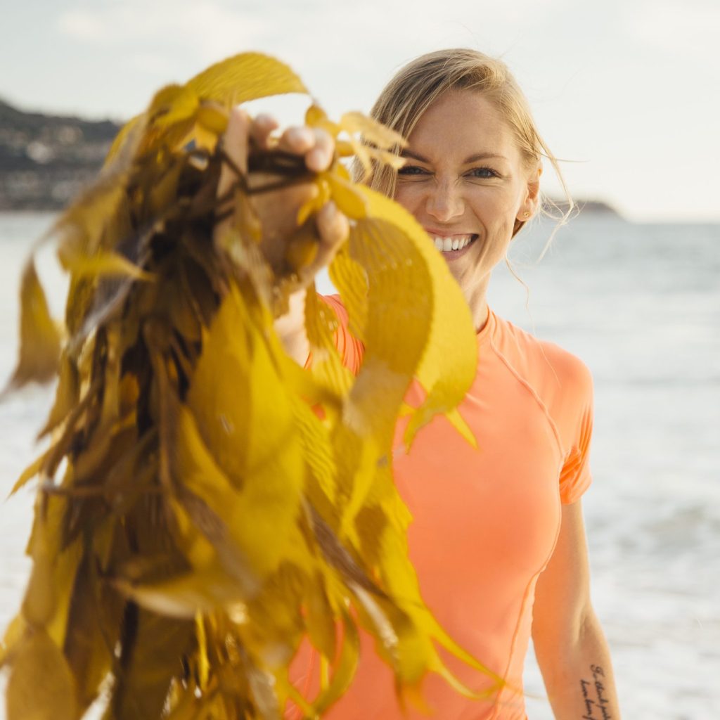Portrait of woman holding seaweed